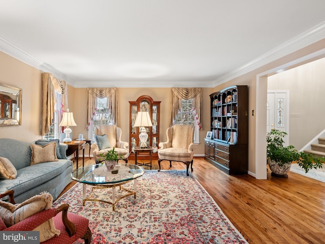 living room with ornamental molding and hardwood / wood-style floors