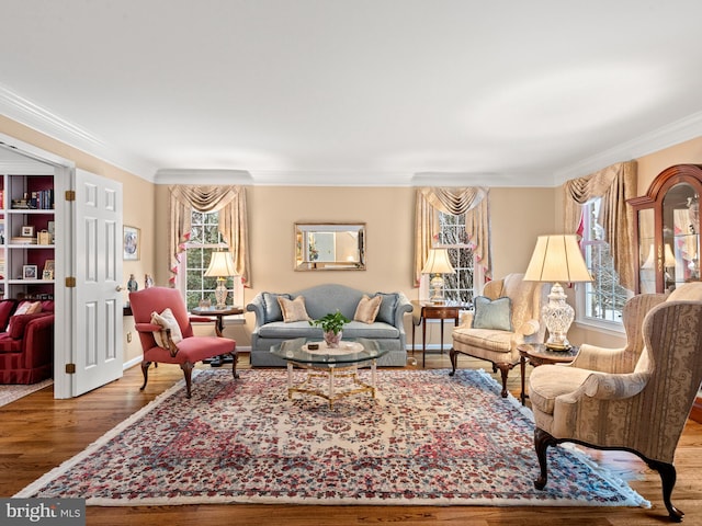 living room featuring crown molding, hardwood / wood-style flooring, and plenty of natural light