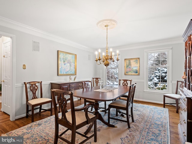 dining space with crown molding, dark hardwood / wood-style floors, and a notable chandelier