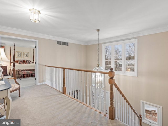 hallway with crown molding and carpet