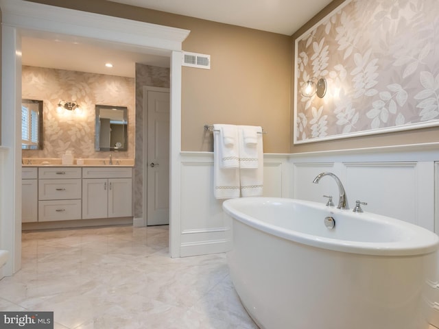 bathroom with vanity and a tub