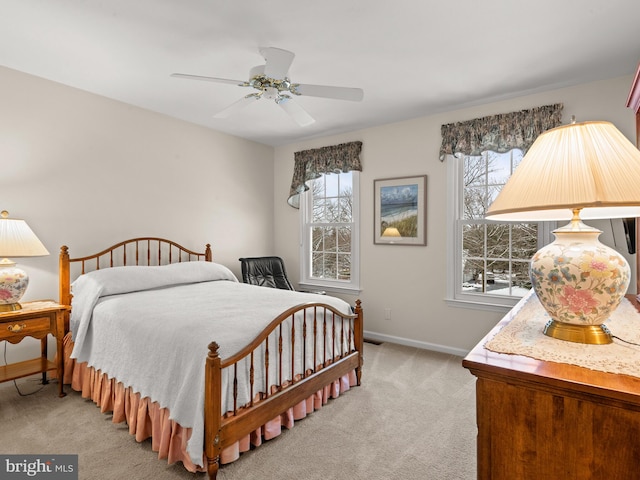 carpeted bedroom with multiple windows and ceiling fan