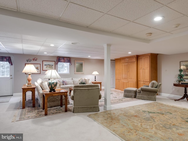 carpeted living room featuring a paneled ceiling