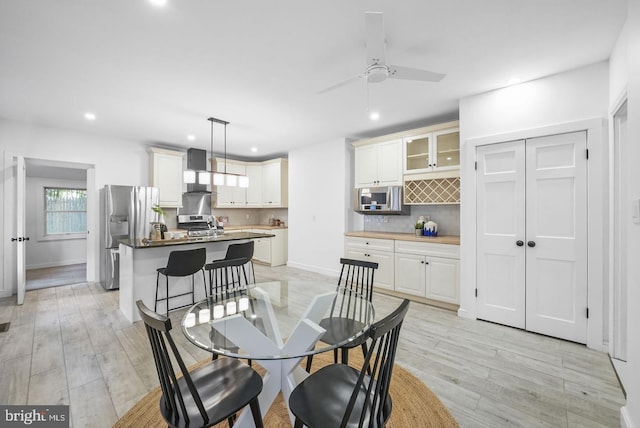 dining area featuring ceiling fan and light hardwood / wood-style floors