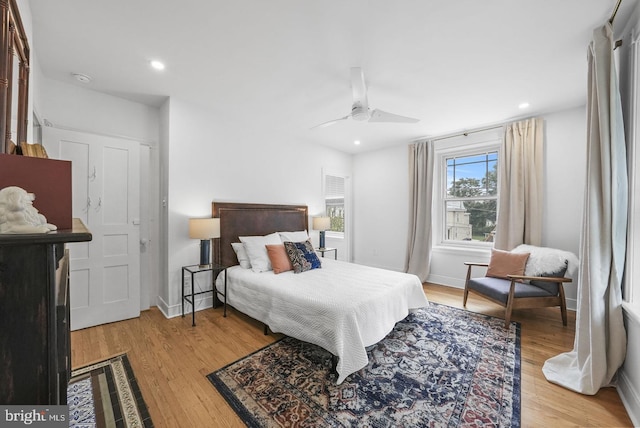 bedroom with ceiling fan and light hardwood / wood-style floors