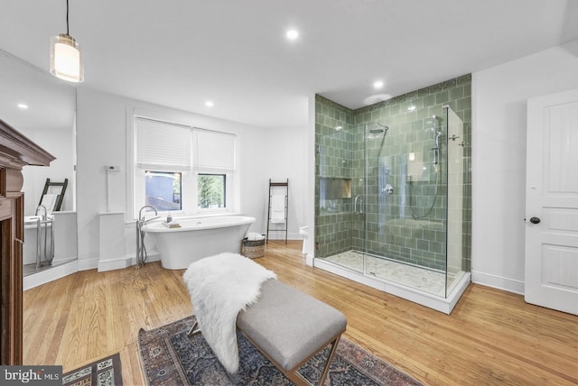 bathroom with wood-type flooring and plus walk in shower