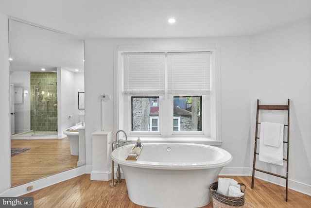 bathroom with separate shower and tub and hardwood / wood-style floors