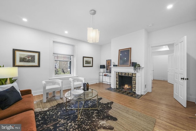 living room featuring hardwood / wood-style flooring and a fireplace