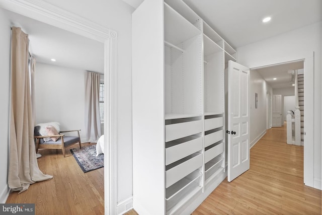 spacious closet featuring light hardwood / wood-style flooring