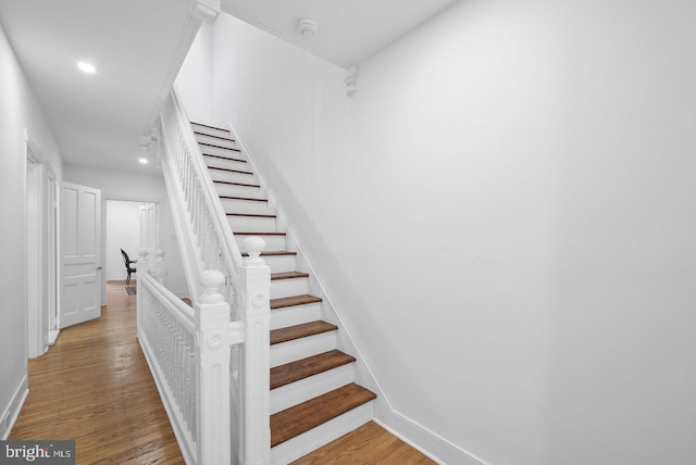 staircase with hardwood / wood-style flooring