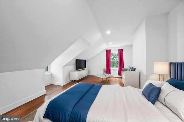 bedroom with lofted ceiling and hardwood / wood-style flooring