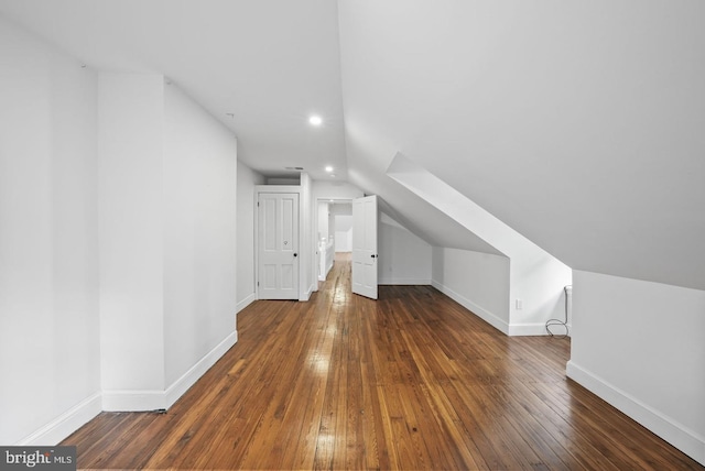 bonus room with lofted ceiling and dark hardwood / wood-style floors