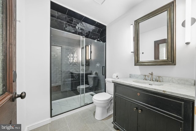 bathroom featuring vanity, an enclosed shower, and toilet