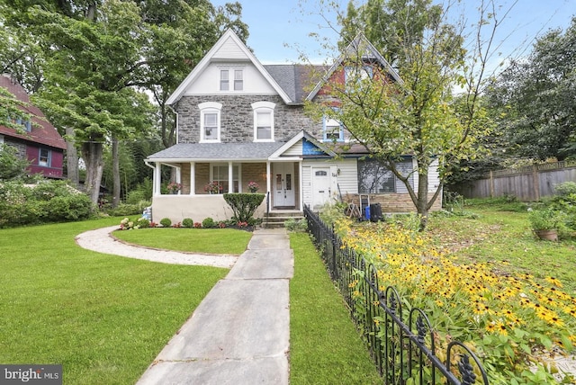 view of front of house featuring a front yard and covered porch