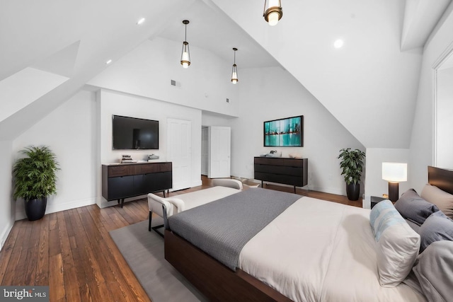 bedroom featuring high vaulted ceiling and hardwood / wood-style floors