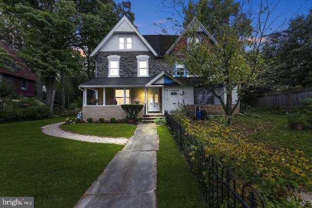 view of front facade with a yard and covered porch