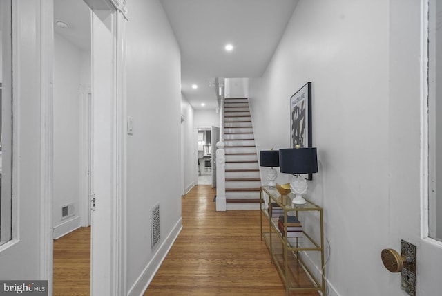 corridor with hardwood / wood-style floors