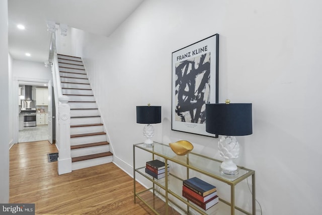 stairway featuring hardwood / wood-style floors