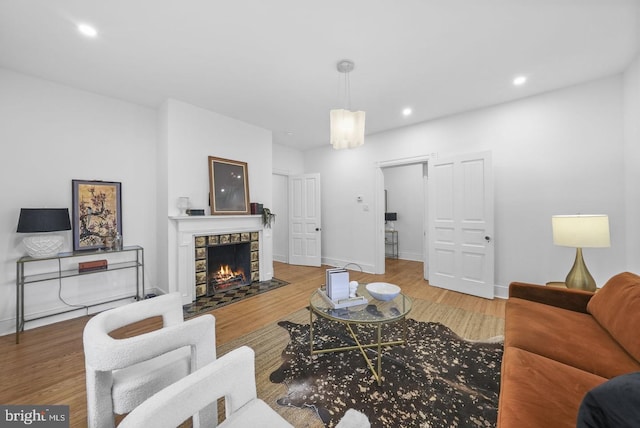 living room featuring hardwood / wood-style floors and a stone fireplace