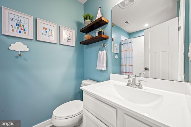 bathroom featuring visible vents, a shower with shower curtain, toilet, and vanity