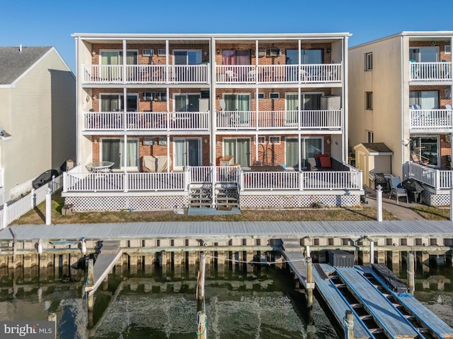 rear view of property with a water view