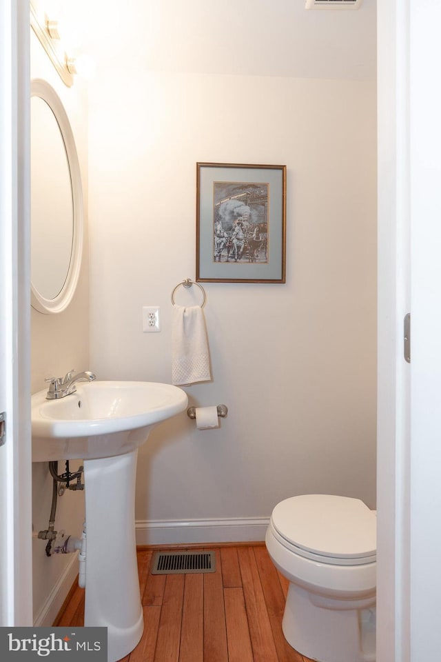 bathroom featuring toilet and hardwood / wood-style floors