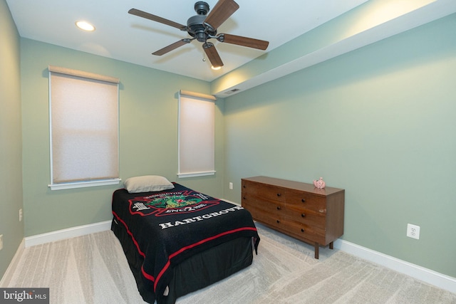 bedroom with ceiling fan and light colored carpet