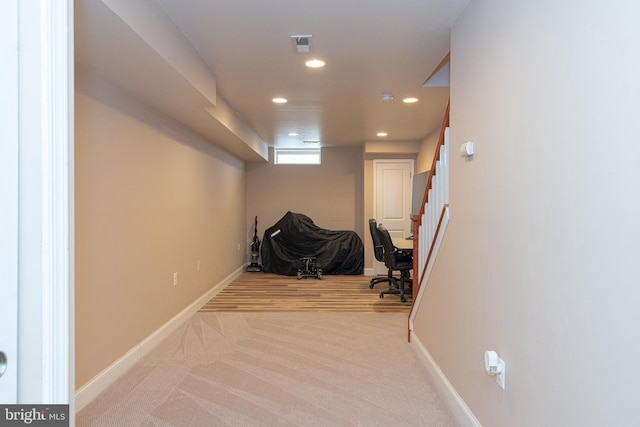 hall featuring light colored carpet