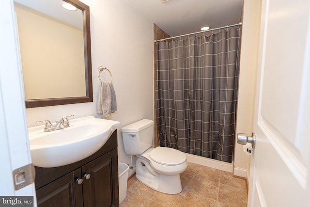 bathroom featuring tile patterned floors, toilet, vanity, and a shower with shower curtain