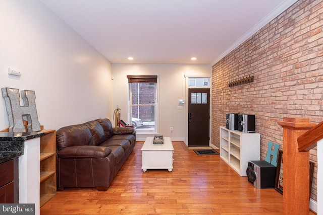 living room with light hardwood / wood-style floors and ornamental molding