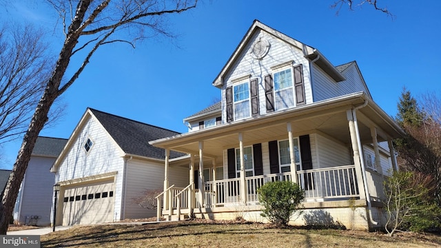 view of front facade with a garage and covered porch