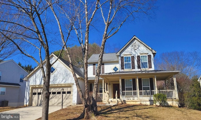 traditional home featuring a porch, concrete driveway, and an attached garage