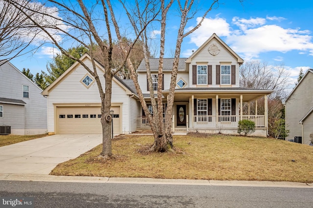 traditional-style house with driveway, an attached garage, central air condition unit, a porch, and a front yard