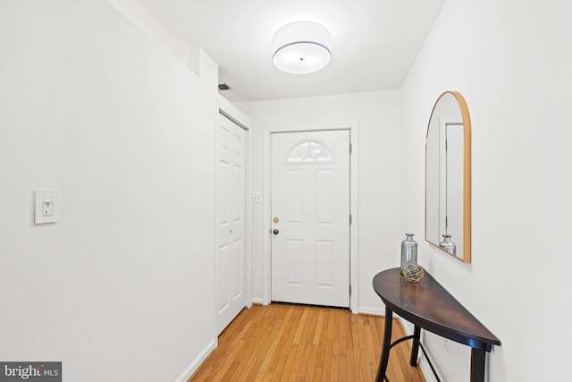 entryway featuring light wood-style floors and baseboards