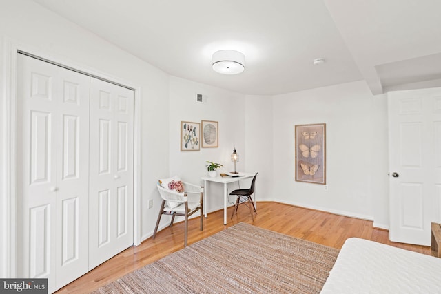 home office featuring visible vents, baseboards, and wood finished floors