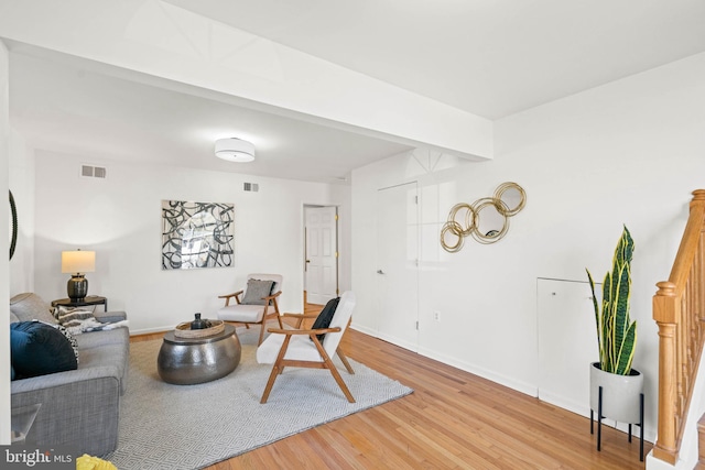 living area with light wood-type flooring, baseboards, and visible vents