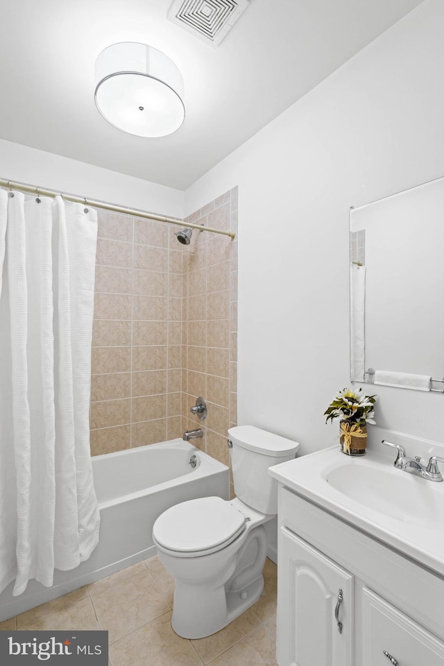 bathroom with visible vents, toilet, shower / tub combo, vanity, and tile patterned floors