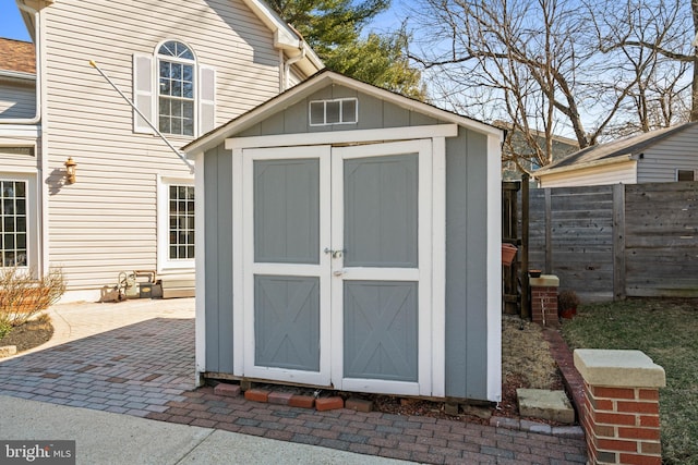 view of shed with fence