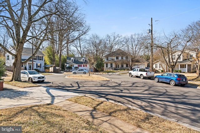 view of road with curbs, sidewalks, and a residential view