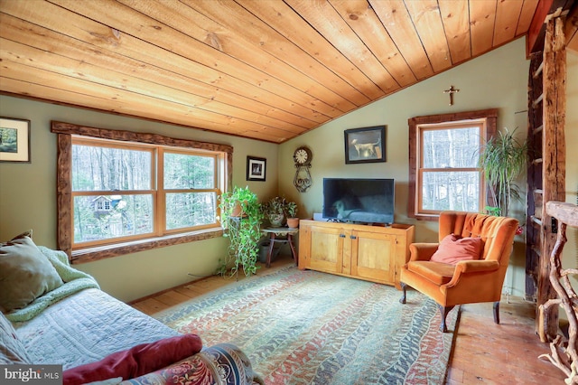 living area featuring lofted ceiling, light wood-type flooring, wooden ceiling, and a wealth of natural light