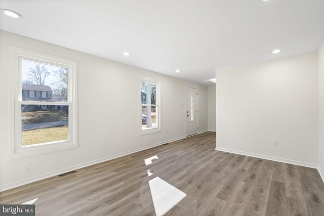 spare room featuring recessed lighting, baseboards, visible vents, and light wood finished floors