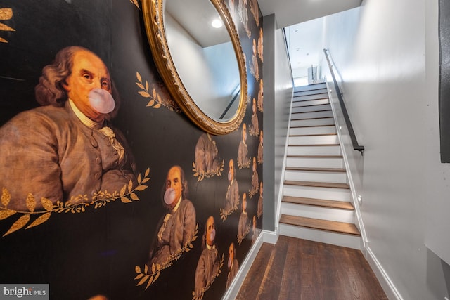 stairway featuring baseboards and wood finished floors