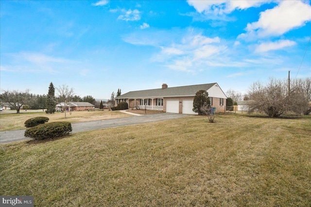 exterior space with a garage, driveway, a chimney, and a front lawn