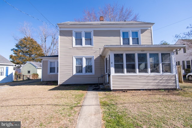 exterior space featuring a yard and a sunroom