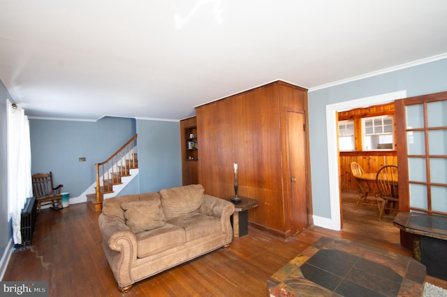 living room featuring ornamental molding and dark hardwood / wood-style floors