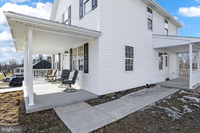 view of property exterior with a porch