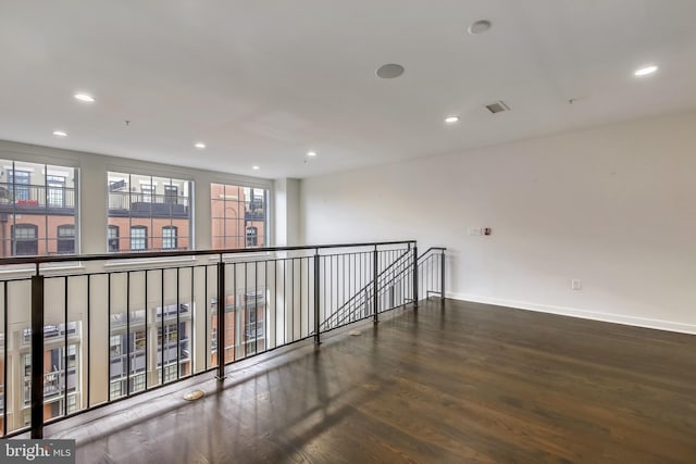 unfurnished room featuring recessed lighting, baseboards, and wood finished floors