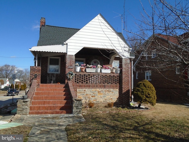 view of front of house featuring a front yard and covered porch