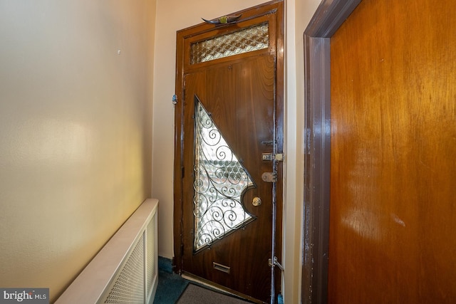 doorway to outside featuring radiator heating unit