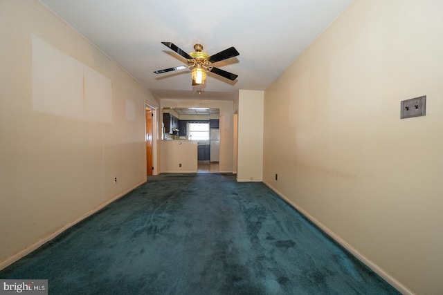 interior space featuring carpet, baseboards, and a ceiling fan